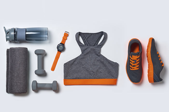 Image of a grey and orange, women's gym kit