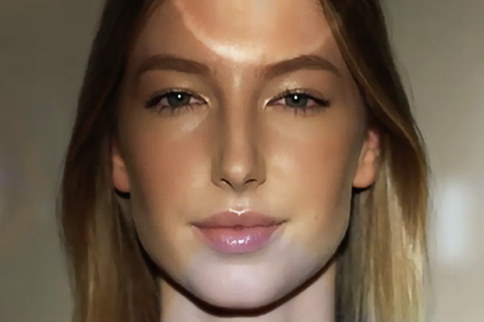 Front view of a woman's face with light reflecting on her
