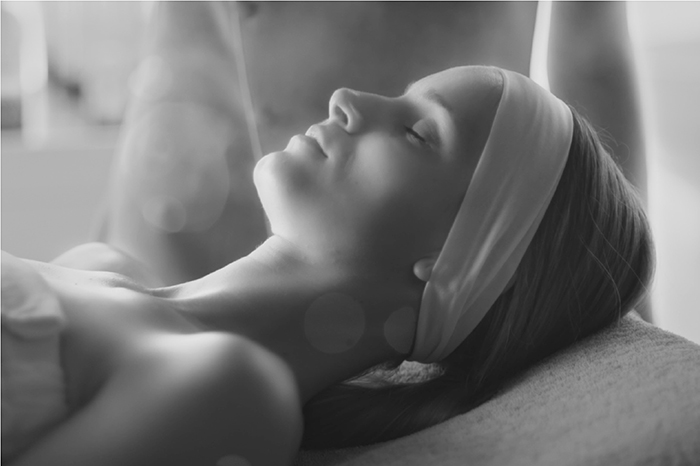 Back and white image of a women relaxing during skin peel