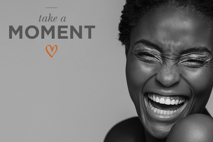 Black and white, woman with open hair, looking down and smiling