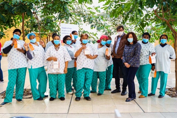 Dr Des Fernandes takes a picture with hospital of hope staff